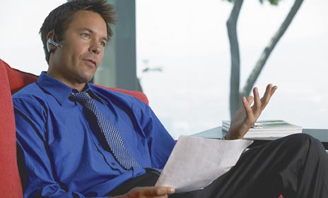 A man using the Voyager Bluetooth headset