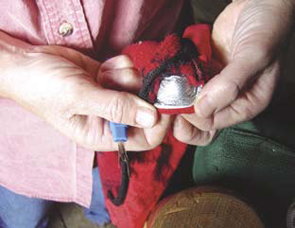 A look at the silver reflective material that is sewn into a pair of red gloves