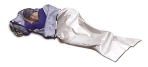 A camper demonstrates the emergency sleeping bag that maintains body heat