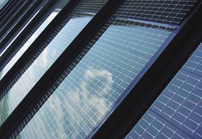 A picture of solar cells reflecting the clouds in the sky