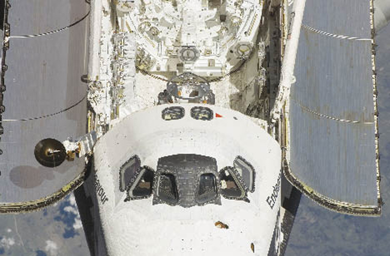 Space Shuttle Endeavour’s solar panels absorb energy.