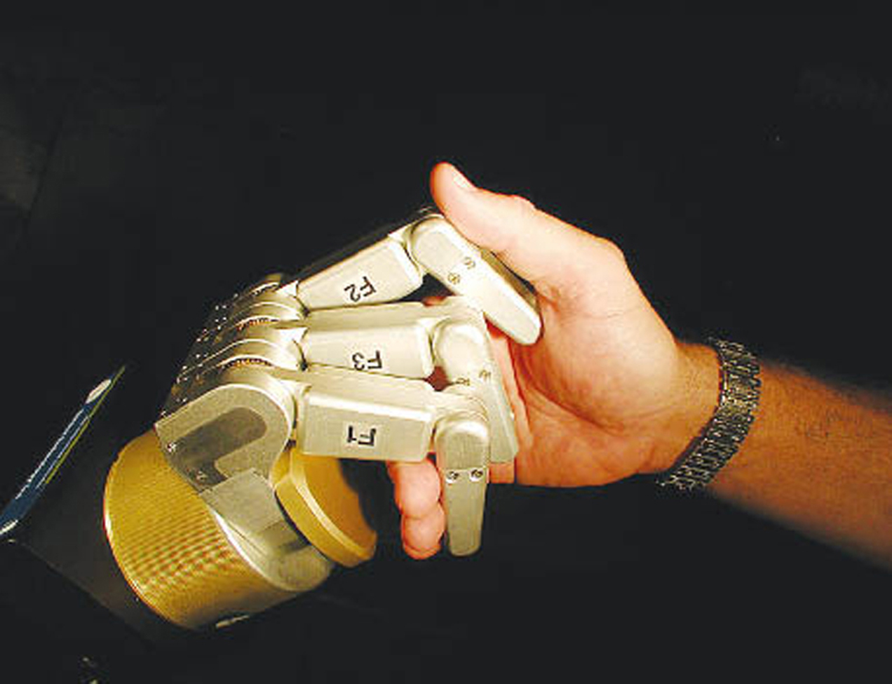 BarrettHand grasps a human hand.