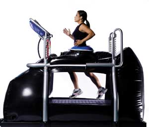 An athlete runs in the pressurized, enclosed G-trainer treadmill.