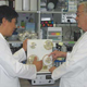 Two scientists examine a bioreactor.