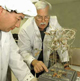Two scientists inspect soybeans grown in space.