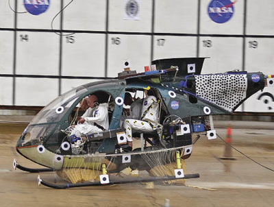 Helicopter with crash test dummies hits the ground and is cushioned by airbags 