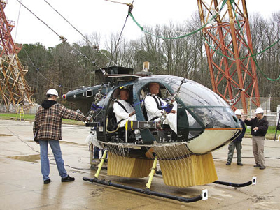 Researchers preparing a test helicopter with crash test dummies Researchers preparing a test helicopter with crash test dummies