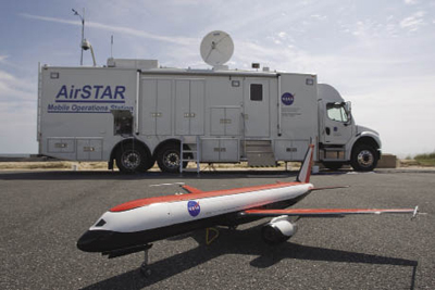 Miniature model aircraft on tarmac in front of mobile test facility truck Miniature model aircraft on tarmac in front of mobile test facility truck