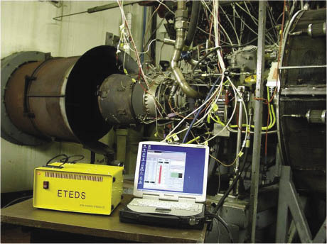 Laptop connected with wires to a turbine engine Laptop connected with wires to a turbine engine