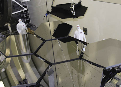 Workers observing assembly of the James Webb Space Telescope primary mirror  