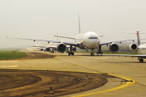 Planes waiting on a runway 