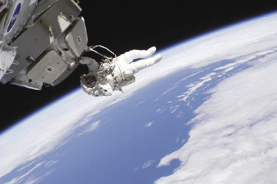 An astronaut spacewalking outside the International Space Station An astronaut spacewalking outside the International Space Station