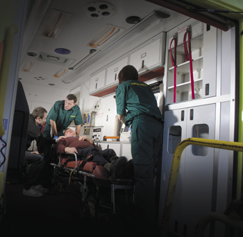 Emergency response personnel treat a patient Emergency response personnel treat a patient