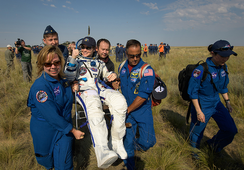 NASA Astronaut Anne McClain carried on chair after landing