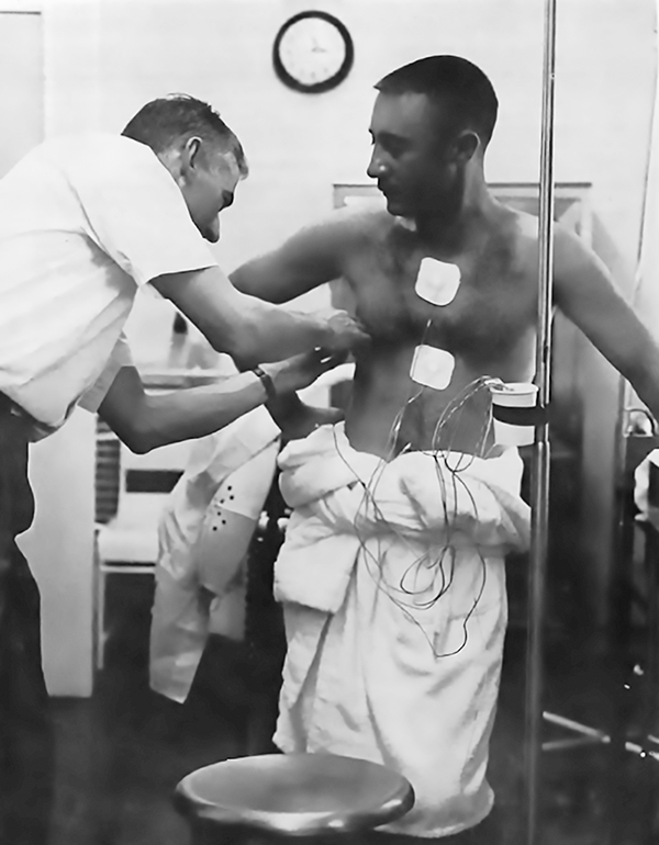 Astronaut Gus Grissom is fitted with health sensors