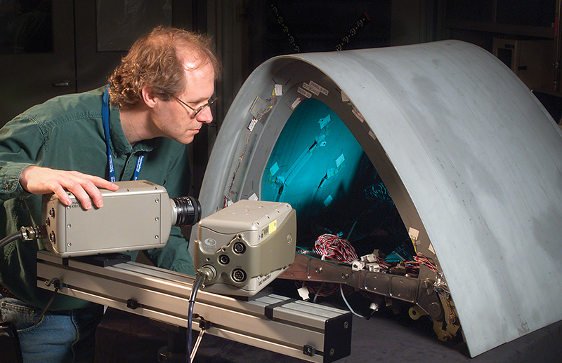 An engineer calibrates high speed cameras to use in stereo-photogrammetry analysis