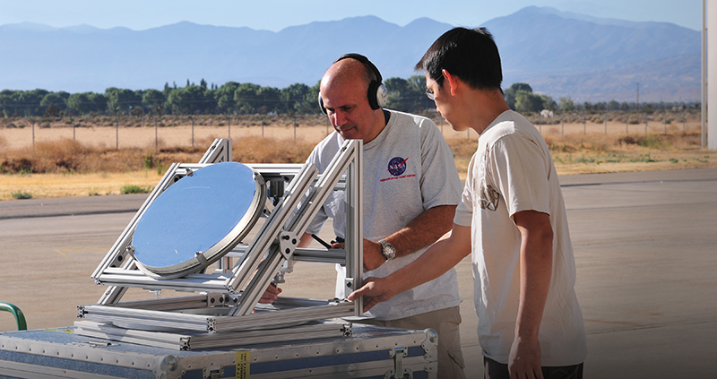 Haris Riris and Stewart Wu tinker with a Methane Sounder prototype