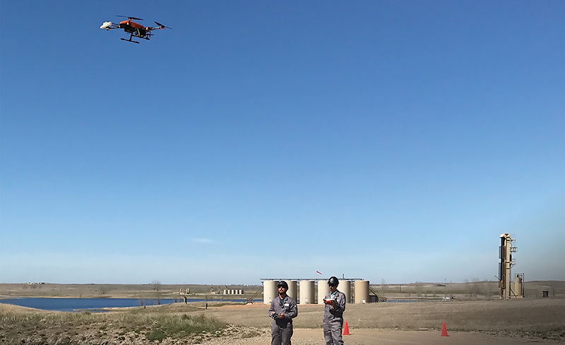 Technicians fly a drone outfitted with SeekOps’ methane detector