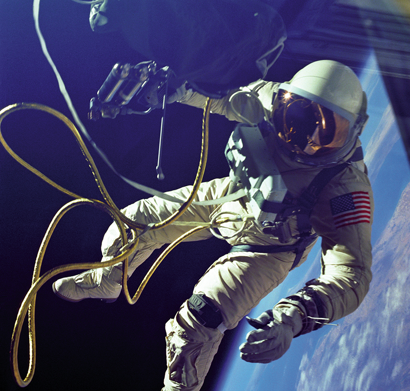 Astronaut Edward White spacewalks above the Earth