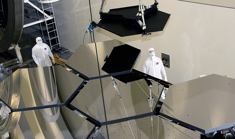 Workers observing assembly of the James Webb Space Telescope primary mirror