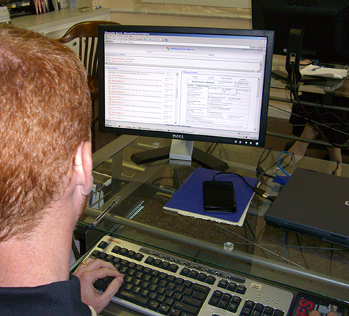 View over a user’s shoulder of AIOXFinder software displayed on a monitor