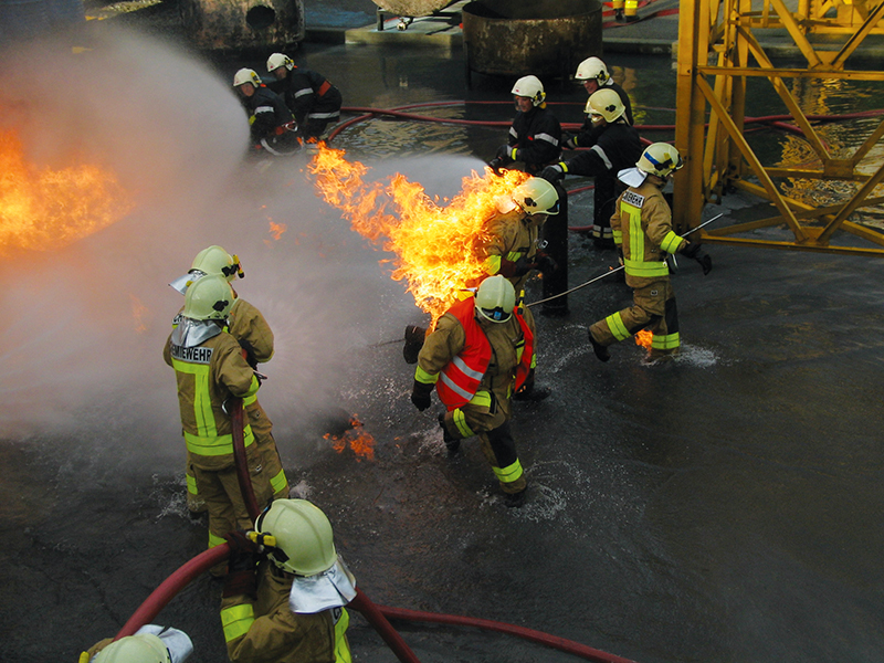 Firefighters wearing protective PBI suits during a training fire