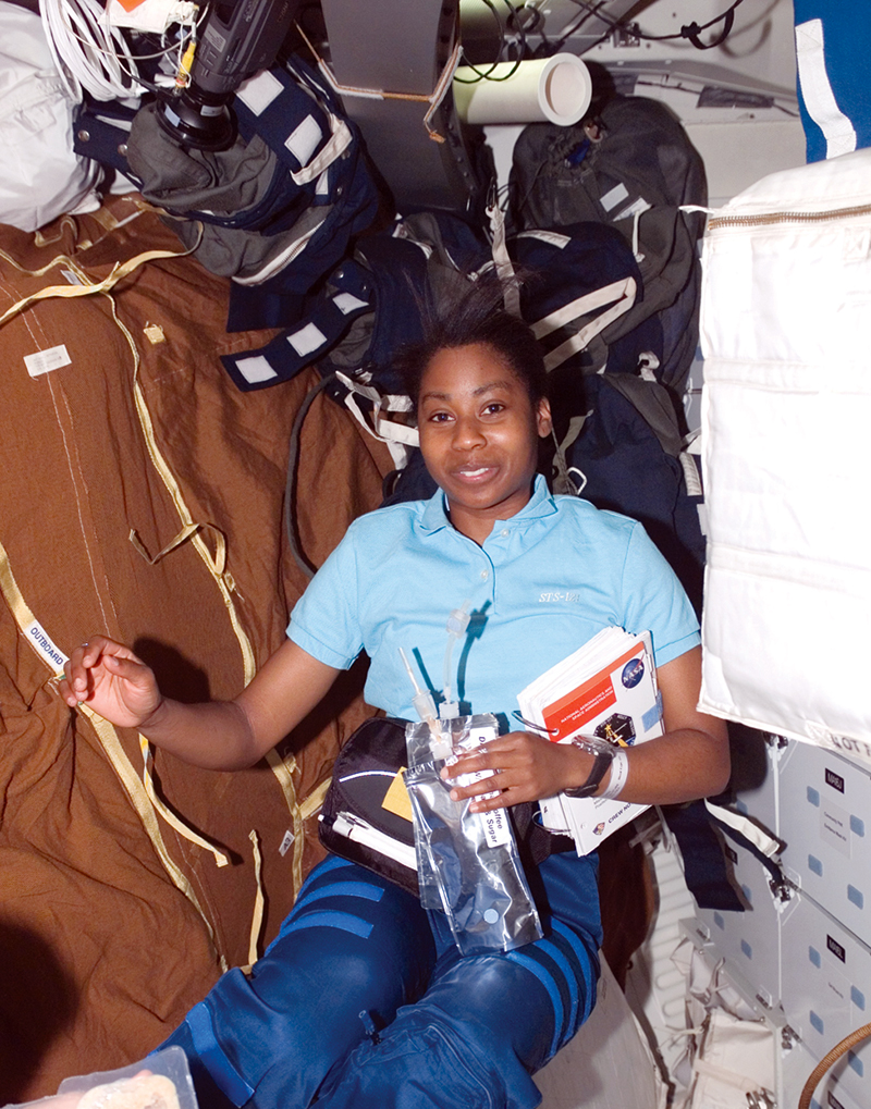 Astronaut Stephanie Wilson drinks filtered water while floating in low gravity
