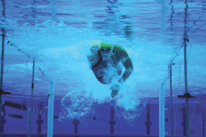 An athlete swims toward the camera