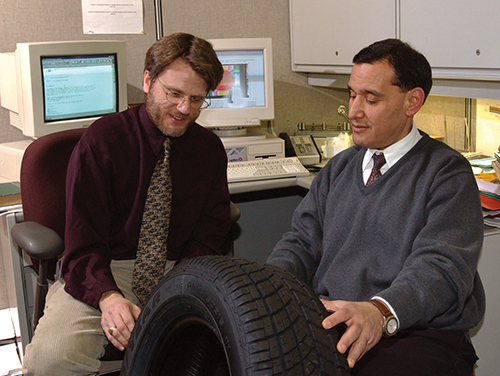 NASA's Dr. Steven Arnold (left) and Goodyear Tire & Rubber Co.'s Dr. Mahmoud Assaad inspect a MAC-manufactured tire