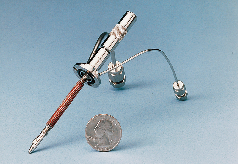 A prototype J-T cryostat-cooled HPGe high-resolution gamma-ray detector with a quarter to show scale
