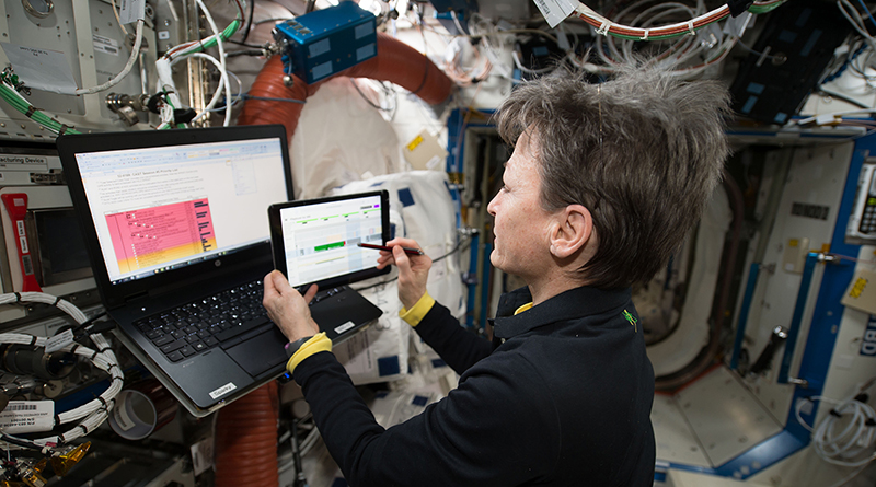 NASA astronaut Peggy Whitson works with an iPad on the International Space Station
