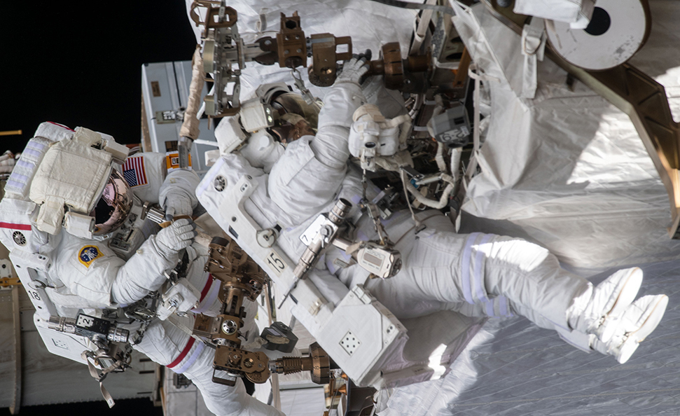 Two astronauts on a space walk outside the ISS