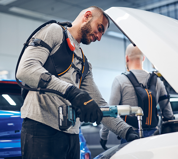 Swedish company Bioservo Technologies’ Ironhand robotic glove being used with a power tool under a car hood