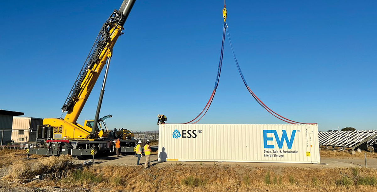 ESS flow batteries installed in a shipping container are moved with a crane