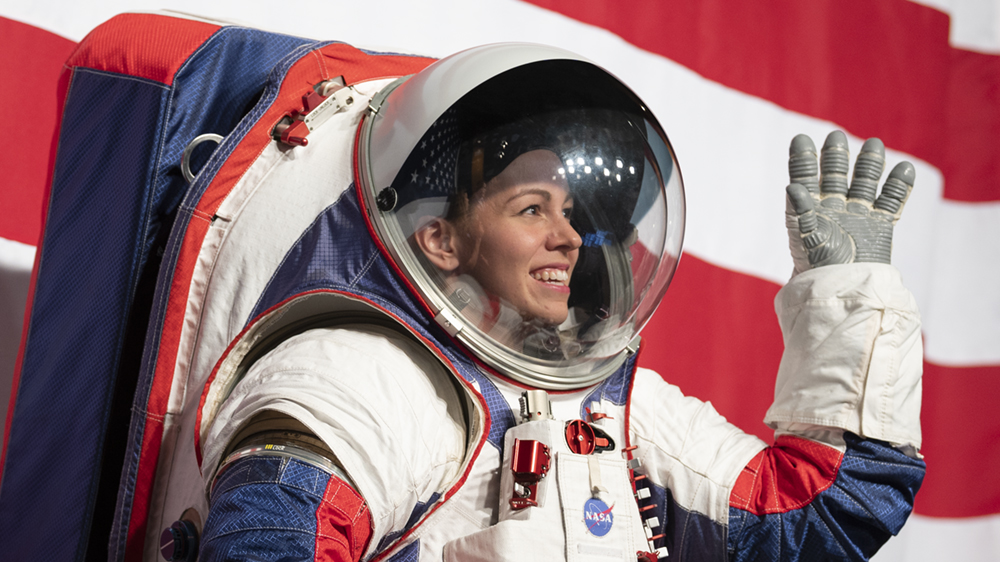 An engineer wears a prototype astronaut suit