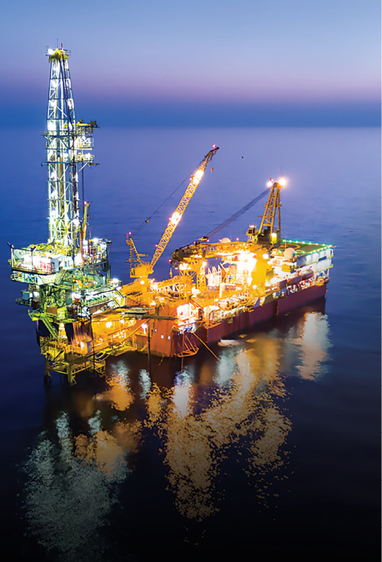 An offshore oil platform is lit up at night