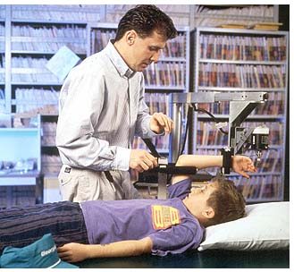 A technician measure the stiffness in a boys ulna