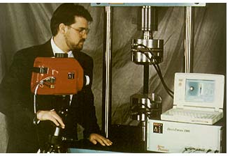 of a man operating the Delta 1000 stress measurement system with its infrared camera