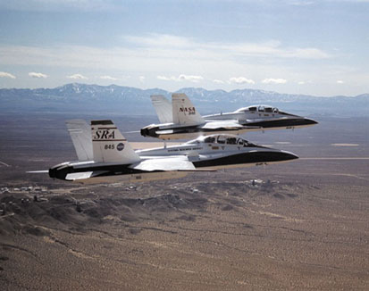 Two F/A-18B aircraft fly in tight formation