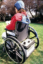 patient in wheel chair with cooling control unit mounted on the rear platform of wheel chair