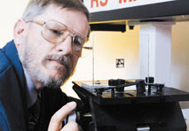 man inspects laser applied product labeling