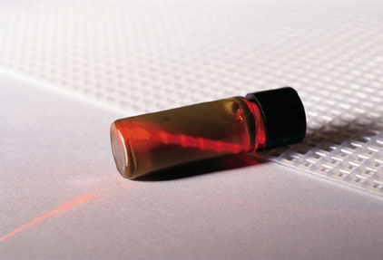 a vial with a laser passing through it during a sampling procedure