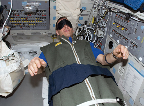 Astronaut sleeping on ISS