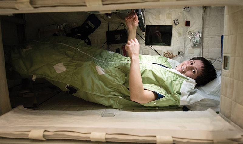 An astronaut prepares to sleep on the International Space Station.