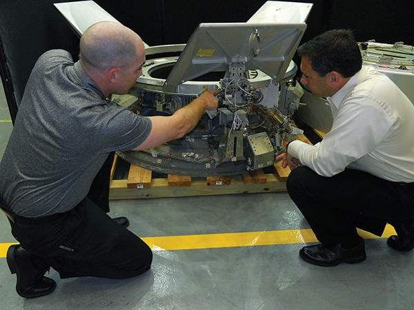 A payload specialist trains a researcher on how to pack payloads