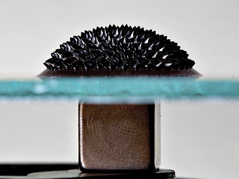 Ferrofluid reacting to square magnet through glass