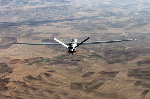 A drone flying over an arid stretch of land