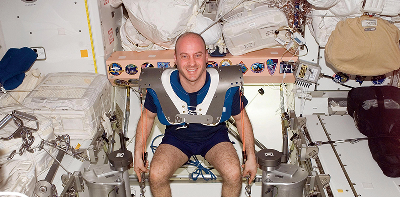 Astronaut Garrett Reisman exercising in space