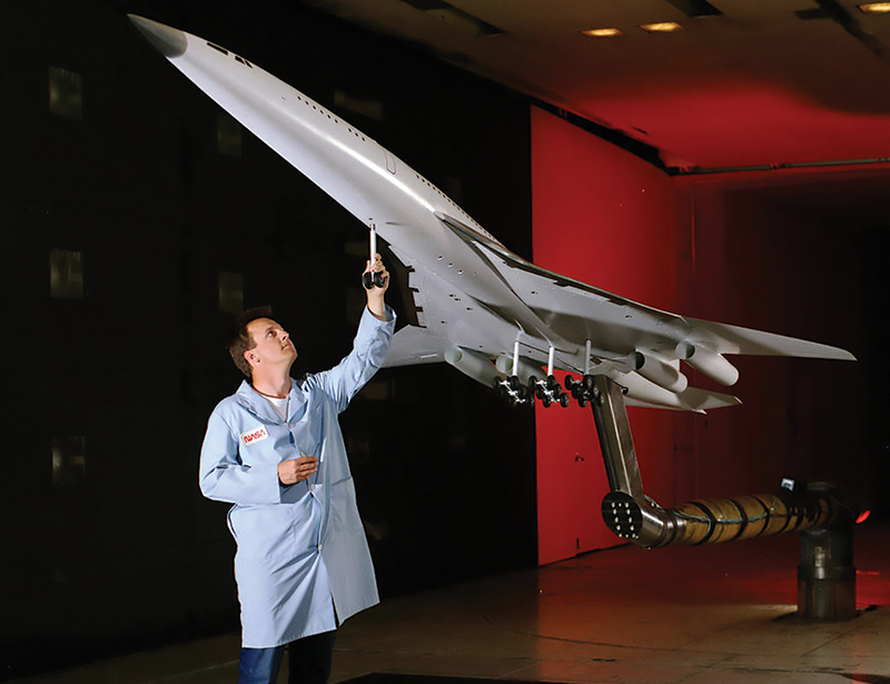 NASA engineer with model of High-Speed Civil Transport aircraft