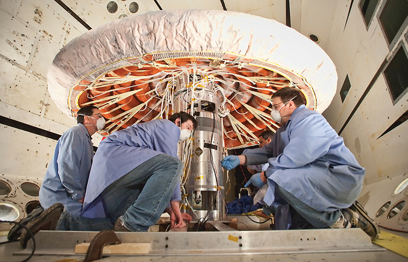 Engineers examining inflated heat shield